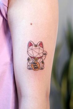 a cat tattoo on the left arm and right arm with an origami design