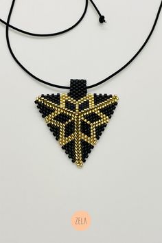 Handmade high-end geometric jewelry made with glass beads. Gift Beaded Gold Choker Necklace, Gift Gold Beaded Choker Necklace, Gift Gold Beads Choker Necklace, Gold Beads With Black Details As Gift, Gold And Black Beads As Gift, Gold And Black Beads Gift, Gold Pendant Necklace With Black Beads, Gold Pendant Beads For Jewelry Making, Adjustable Gold Choker With Spacer Beads