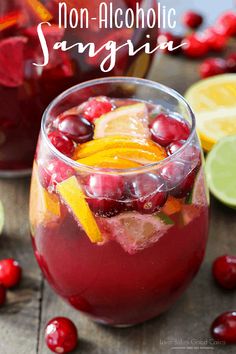 cranberry orange sangria in a glass with limes and cherries