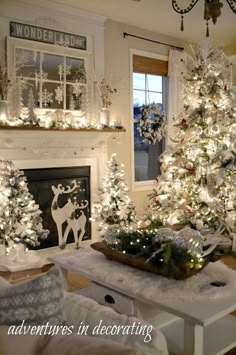 a living room decorated for christmas with white trees and lights on the fireplace mantel