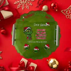 a green plate with an image of a cartoon character on it surrounded by christmas decorations