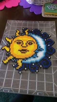 the sun and moon are made out of perler beads on top of a table