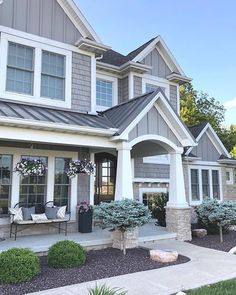 a house with gray siding and white trim