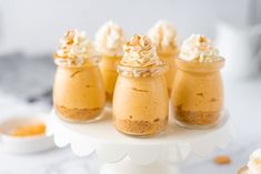 mini desserts in small glass jars on a cake stand