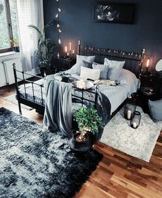 a bed room with a neatly made bed and candles