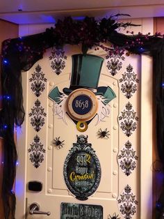 a white door decorated with black and purple decorations on the front, surrounded by blue lights