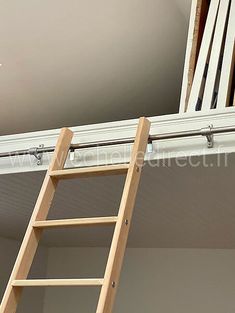 a ladder is attached to the ceiling above a bed