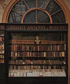 an old book store with many books on it's shelves and the doors open