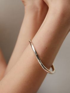 Editor's Notesgemma alus design presents a textured silver bangle. It is an excellent item to highlight your wrist and arm. - Textured bangle- Made of silver 925- Curved design- Causal and unique mood Measurements(in.)One Size- Size: 2.56 in. (W) * 2.09 in. (H) Composition & Care- Material: 925 Silver- Plated products may discolor over time due to their nature.- Please be careful that discoloration may proceed faster in chemical substances, water, and heat.- As all j Elegant Hand Forged Bangle For Everyday Wear, Elegant Hand Forged Bangle For Everyday, Elegant Everyday Hand Forged Bangle, Luxury Hammered Bangle Cuff Bracelet, Luxury Hammered Bangle Bracelet, Luxury Hammered Bangle, Modern Hammered Bangle Bracelets, Elegant Hammered Round Bangle, Elegant Hand Forged Bangle Bracelet