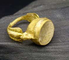 a gold ring sitting on top of a black cloth