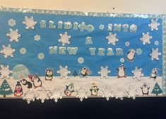 a bulletin board with penguins and snowflakes on it that says sledddo is a new year