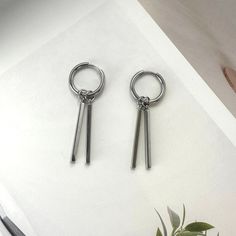 Upgrade your streetwear game with these Metal Bar Dangle Drop Earrings. They feature a unisex style that is perfect for both men and women. With a hip hop vibe and unique design, these earrings will make you stand out in any crowd. Add a touch of edgy and stylish flair to your everyday look. Earrings length 1.6 inch width 0.6 inch. Trendy Metal Earrings For Streetwear, Silver Trendy Hoop Earrings For Streetwear, Trendy Metal Hoop Earrings For Streetwear, Silver Hoop Earrings For Streetwear, Edgy Jewelry, Punk Earrings, Earrings For Men, Women Streetwear, Mens Accessories Jewelry