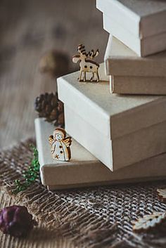 three books stacked on top of each other with christmas decorations in front of the pages