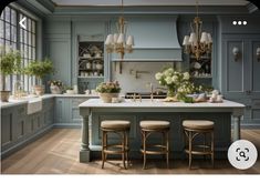 an image of a kitchen setting with stools in the middle and flowers on the island