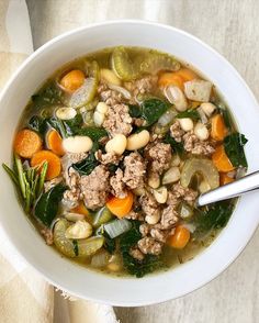 a white bowl filled with meat and vegetables