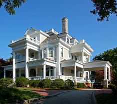 a large white house sitting on the side of a road