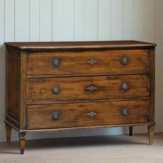 an old wooden chest of drawers in a room