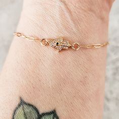 This sweet and sparkly tiny crystal Hamsa is perfect for anyone in your life who wants to show their Jewish pride in a minimalist style. It's a classic and understated must have for everyone.  *A portion of every sale in this shop will be donated to American Friends of Magen David Adom All bracelets come beautifully and simply packaged in box and bow ready for gifting. ABOUT THE JEWELRY * The gold plated crystal hamsa is tiny ~9mm.  * The 14k gold filled paper clip chain can be adjusted and is d Jewish Pride, Pride Jewelry, Crown Decor, Hamsa Evil Eye, Pride Jewellery, Hamsa Bracelet, Hamsa Charm, Gold Hamsa, Bracelet Dainty