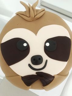 a close up of a cake shaped like a slotty face with a bow tie