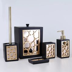 an assortment of black and gold bathroom accessories