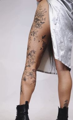 a woman's legs with tattoos on them