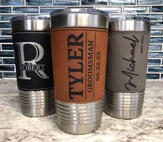 three personalized tumblers sitting on top of a counter