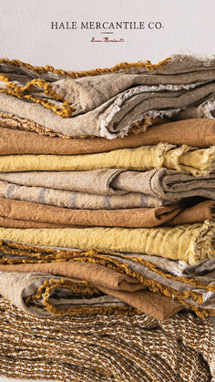 a pile of folded clothes sitting on top of each other