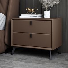 a brown nightstand with two drawers next to a bed and a plant on top of it