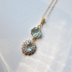 This beautiful geometric necklace is the perfect wedding day accessory for the modern bride. The crystal necklace is created with a delicate 14k gold filled necklace at the length of your choice. Secured to the pendant is faceted light blue glass framed with cubic zirconia for added sparkle. Whether searching for blue wedding jewelry for your bridesmaids or something blue for your next special occasion, all of my jewelry arrives suitably gift wrapped ready for gift giving. Complete the look with Blue Clavicle Chain Necklace For Wedding, Gold Teardrop Crystal Necklace For Wedding, Dainty Blue Necklace For Wedding, Elegant Gold Crystal Necklace For Wedding, Crystal Clavicle Chain Necklace For Wedding, Delicate Gold Crystal Necklace For Wedding, Gold Crystal Gemstone Necklace For Wedding, Gold Gemstone Crystal Necklace For Wedding, Delicate Crystal Clavicle Chain Necklaces For Wedding