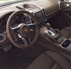 the interior of a sports car with brown leather trims and steering wheel, dashboard