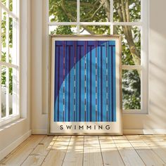 a poster with the words swimming on it in front of an open window and trees