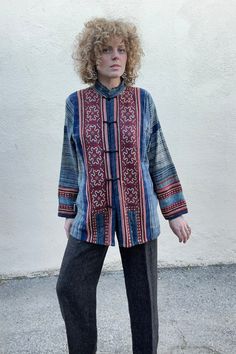 Vintage Blue Embroidered Block Printed Jacket. Stunning vintage top with fabric button closures. Soft lightweight block printed indigo blue cotton with red and brown folk art embroidered panels in front and back and along bottom of sleeves. Delicately hand wash cold. Size L/XL. Fits many. Feels like 100% cotton. Approx. Measurements: Underarm to underarm: 25" Length: 30” Sleeve length: 28” Blue Folk Style Outerwear For Fall, Long Sleeve Cotton Tops With Woven Motifs, Blue Embroidered Cotton Outerwear, Long Sleeve Cotton Top With Woven Motifs, Traditional Blue Tops For Fall, Bohemian Cotton Outerwear With Stand Collar, Folk Style Blue Outerwear For Fall, Red Folk Cotton Outerwear, Blue Folk Style Fall Outerwear