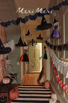 Hallway decorated with a striped black and white rug and pumpkins, with paper witch, bat, ghost, pumpkin and skeleton   decorations. Halloween Whimsical Decor, Kid Halloween Party Decorations, Halloween Decorations Kids Party, Halloween At Home Ideas, Halloween Home Made Decorations, Halloween Decor Hallway, Halloween House Aesthetic, Kid Friendly Halloween Decor, Whimsical Halloween Decor