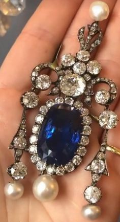 Antique blue sapphire 7.90 ctw. CZ zircon American Diamond 925 silver drop Brooch for women Metal: Sterling Silver Metal Purity: 925 Metal Wt: 13.100 Grams Stone Type: 100% Natural CZ Zircon Stone Color: white Diamond I-J Stone Clarity: AAA+ Stone Cut: Good Stone Shape: Round  Stone Wt: 7.90 Ctw Gemstone :Blue sapphire,pearl Gemstone wt: 3.4 ctw Dimension:  Length: 2.5 Inches Breadth:1.7 inches Product Color: Oxidized Black Rhodium on Diamond and Gold Rhodium on Sterling Silver 5 star service available  *Handmade item# *Free shipping worldwide# *Free engraving# *For other queries contact us any time # *Metal available: Sterling Silver Rose gold, yellow gold, white gold # *Service available 24/7# * Customisation available# * Our main focus to give 100% quality products to our buyers with sa Neck Pieces Jewelry, Historical Jewellery, Antique Blue, Diamond Brooch, Royal Jewels, Pearl Gemstone, Victorian Jewelry, Black Rhodium, American Diamond