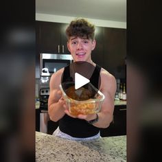 a young man is holding a bowl with food in it