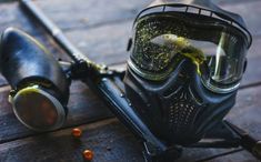 a scuba mask and goggles on a wooden surface