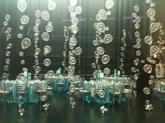 a room filled with lots of tables and chairs covered in bubble like bubbles hanging from the ceiling