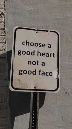 a white sign that says choose a good heart not a good face