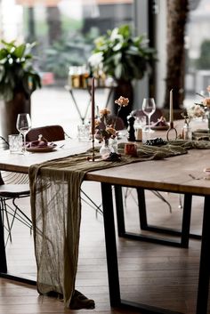 a long table is set up with candles and place settings for an elegant dinner party