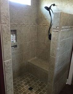 a walk in shower sitting inside of a bathroom