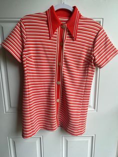 This vintage 1970's red-orange and white striped shirt has buttons for closure.  The collar point is 4 inches, bust is 37 inches and length from shoulder seam to hem is 25.5 inches. To see more of our vintage 1970's clothing inventory as well as our other vintage items please visit our store at ChoiceRecycling.  We add new items every week. Thank you, Karmyn Red Summer Top With Striped Collar, Retro Fitted Top With Vertical Stripes, Vintage Collared Tops With Vertical Stripes, Vintage Collared Top With Vertical Stripes, Vintage Striped Collared Tops, Retro Striped Tops With Button Closure, Retro Striped Collared Blouse, Retro Fitted Striped Blouse, Retro Striped Fitted Blouse