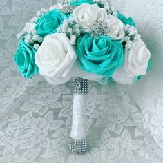 a bridal bouquet with blue and white roses