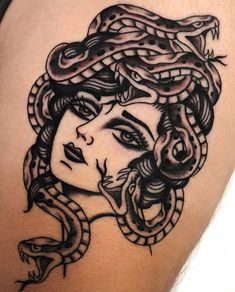 a woman with a snake on her shoulder is shown in black and white tattoo art