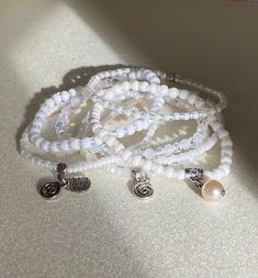 This beautiful set is made with with 4mm & 3mm Miyuki high-quality beads combined with high-quality crystals beads.  We kept in mind that white is often associated with purity, innocence, and simplicity and wearing white beaded bracelets can help you keep hope and stay positive. You can wear each bracelets separately or make a statement by wearing them all together. It is also a wonderful gift for the holidays for brides and bridesmaids. Handmade White Spiritual Charm Bracelet, Bohemian Charm Bracelet With White Round Beads, Bohemian White Charm Bracelet With Round Beads, Spiritual White Beaded Bracelets With Tiny Beads, Spiritual White Beaded Charm Bracelet, White Crystal Bracelet With Tiny Beads For Gift, White Crystal Bracelet With Tiny Beads As Gift, White Crystal Bracelet With Tiny Beads, White Charm Bracelet With Spacer Beads