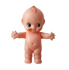 a baby doll with big blue eyes standing up