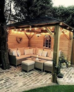 an outdoor living area with couches and lights