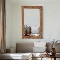 a living room filled with furniture and a large mirror