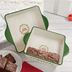 two white dishes with brownies in them sitting on a table next to a red and green napkin