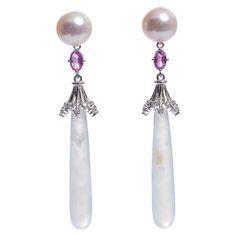 This Earring is consists of Akoya Pearls, Pink Sapphire and Jadeite. The icicle Jadeite is dangling below the Akoya Pearls connected by the pink sapphire. The pink sapphire matches the pink hue of the Akoya pearls while the near colourless icicle jadeite matches the colour of the Akoya pearls too. It is a more casual and younger design and is suitable for everyday wear. 8.3mm akoya pearls, pink sapphire and Diamond Ring in 18k White Gold Total Natural Diamond weight is 0.36 ct , The Colour of th Vintage Stud Earrings, Sapphire And Diamond Ring, White Gold Earrings, Akoya Pearls, Gold Earring, Sapphire Diamond, Pink Sapphire, Jewelry Earrings Studs, The Pink