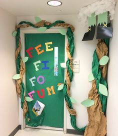 a green door decorated with paper leaves and the words feel flo fum's